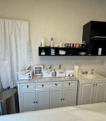 Professional waxing supplies and equipment organized in a clean studio environment.